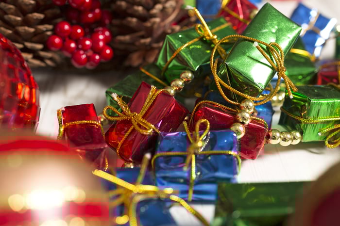 Selection of vibrant Christmas decorations on a light wooden surface